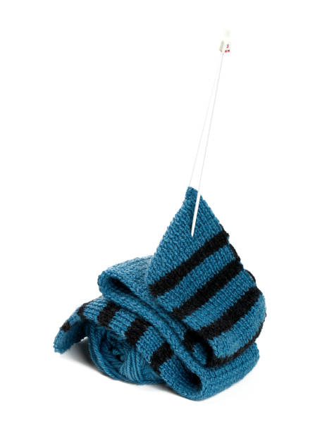 istock striped scarf on knitting needles over white 1169067214