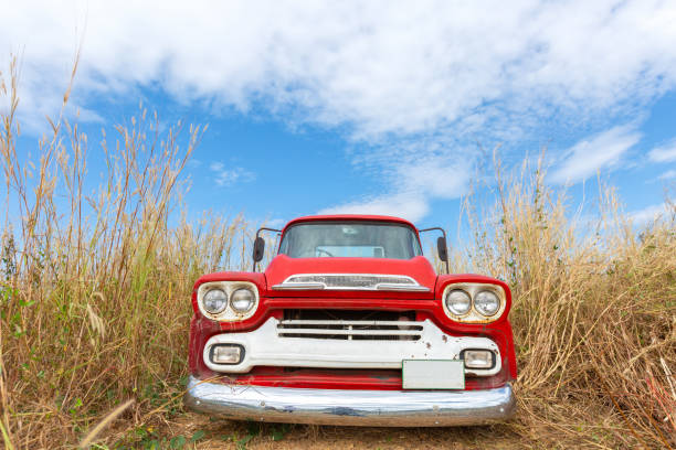 istock Red vintage car with blue sky 1169069449