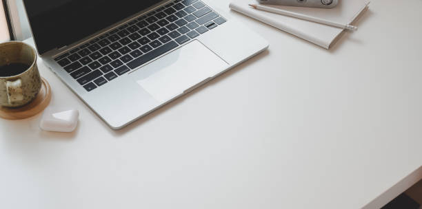 istock Close-up view of minimal workplace with laptop computer 1169069503