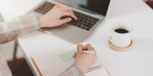 istock Motivated young businesswoman writing her idea on sticky note 1169069532