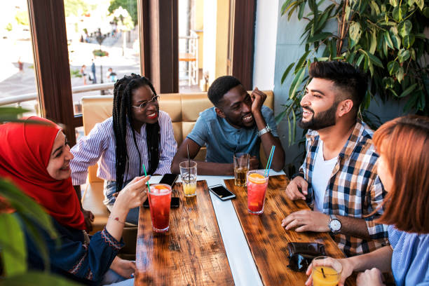 group of happy friends drinking juice and lemonade at cafe. - day asian ethnicity asian culture asian and indian ethnicities imagens e fotografias de stock