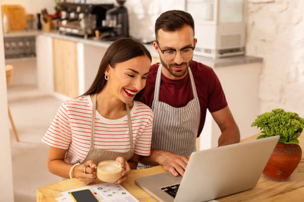 istock Couple feeling excited before opening coffeehouse 1169071561