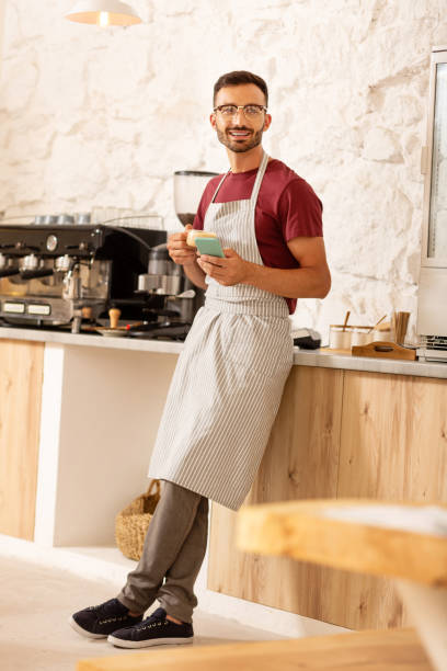 istock Prosperous businessman drinking coffee in his coffee room 1169071579