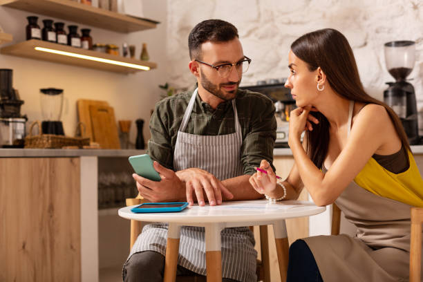 istock Couple having discussion while opening their own cafeteria 1169071769