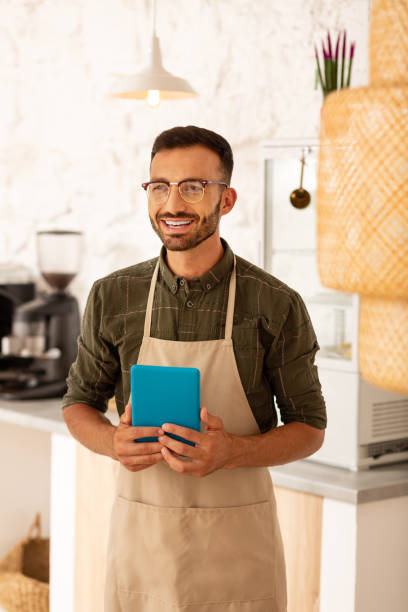 istock Entrepreneur owning coffee shop smiling while feeling happy 1169071854