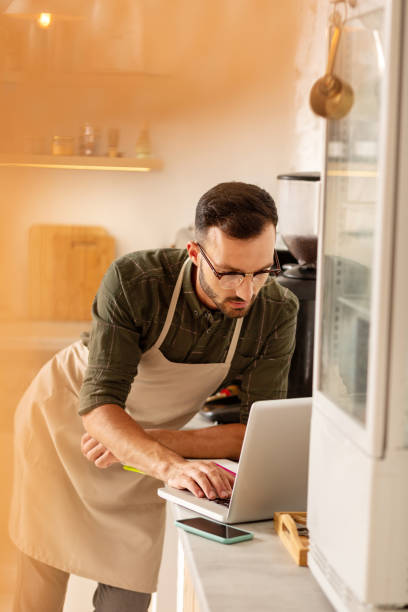 istock Businessman doing bookkeeping while owning coffee shop 1169071894