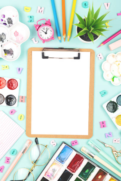 School or office supplies on a desk with copy space. Back to school concept. Variety of stationery or art items with a clipboard. Flat-lay, top view. classroom empty education desk stock pictures, royalty-free photos & images