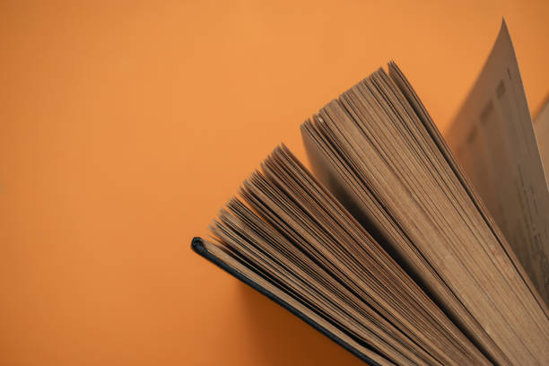 istock Open book on a yellow background. Top view. 1169074268