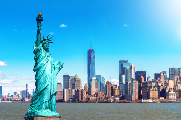 the statue of liberty with the one world trade building center over hudson river and new york cityscape background, landmarks of lower manhattan new york city. architecture and building concept - urban scene city new york city skyline imagens e fotografias de stock