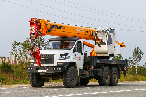 Novyy Urengoy, Russia - July 30, 2019: Modern construction crane Ural 4320 Next at the interurban road.