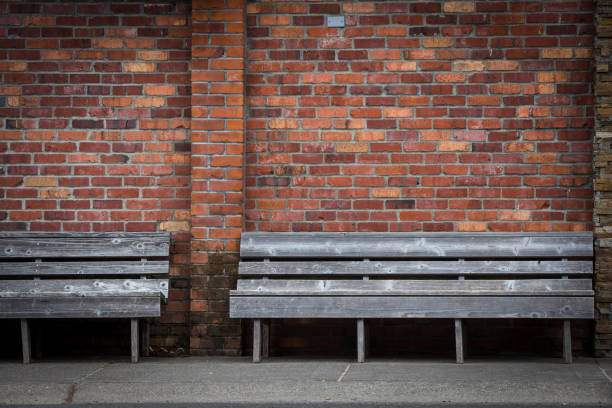 istock City bench against a brick wall. 1169076743