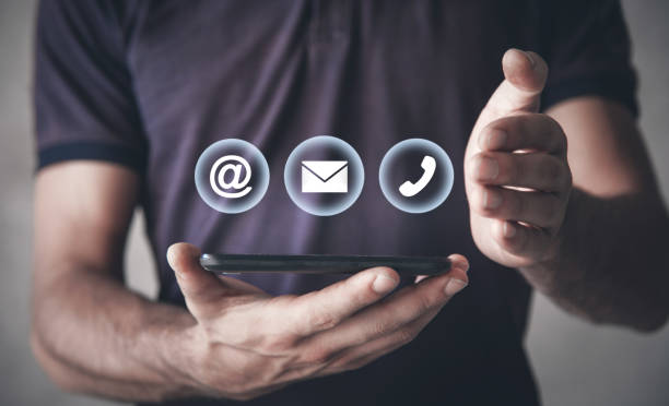 istock Man holding smartphone with contact symbols. 1169078346