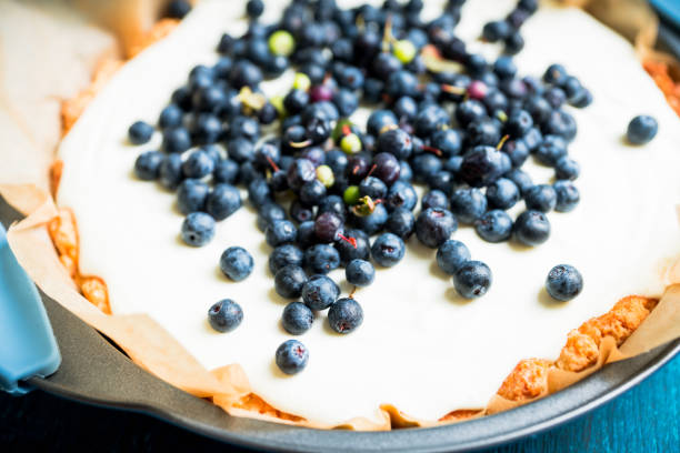 Fresh cheesecake with wild blueberries on the rustic background. Selective focus. Shallow depth of field.