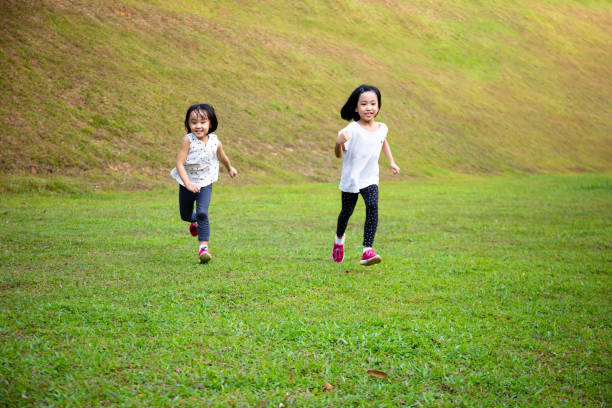istock Asian Little Chinese Sisters running happily 1169083389