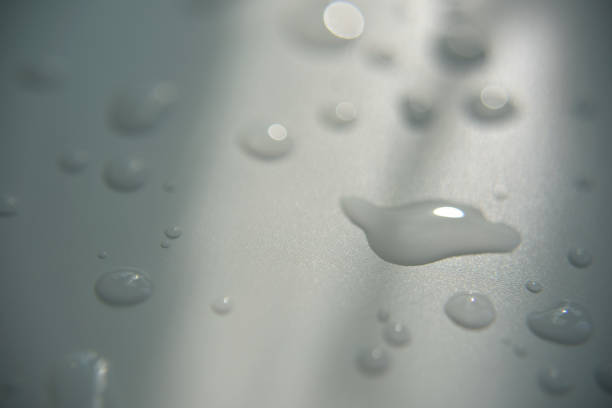 istock drops of clear water on white surface with abstract shadow 1169085165