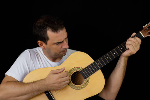 istock Man playing the guitar 1169085359