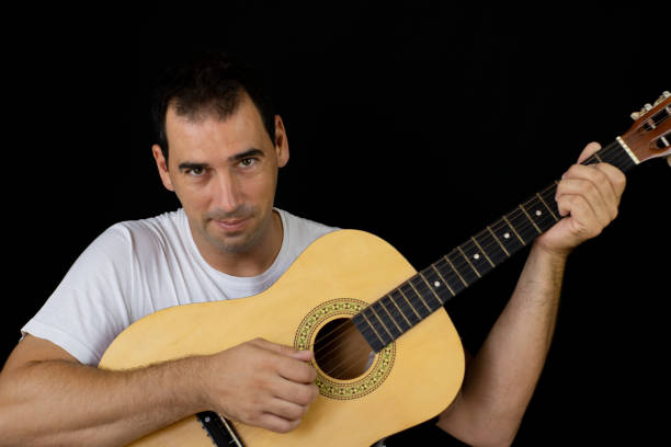 istock Man playing the guitar 1169085360