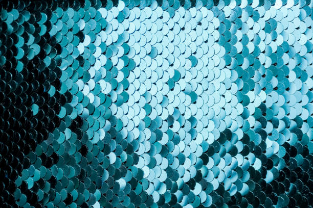 istock Abstract blue Texture with bright Sequins . Glamor scales Background with shiny Sequins on fabric. Beautiful Holiday Wallpaper with pattern of round Sequins.textile texture. Good for disco, party. 1169086436