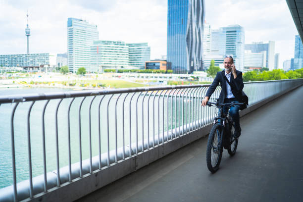 istock environmental friendly way to work, commuter on bike in office district 1169086445