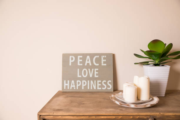 Hipster scandinavian style room interior. Mood board. Old scratched board ,Quote PEACE, LOVE, happiness. White candles,pot with succulents.Rustic style interior.minimalistic style bedroom.