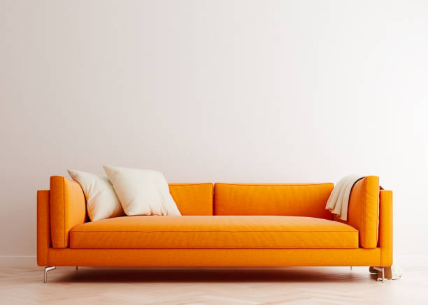 Bright white mock up wall with orange sofa in modern interior background, living room, Scandinavian style, 3D render, 3D illustration stock photo