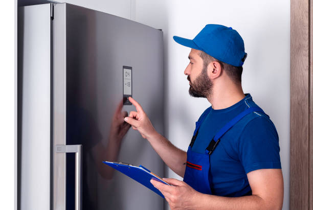 Refrigerator Examining Repairman, Refrigerator, Repairing, Examining, Installing fridge fix stock pictures, royalty-free photos & images