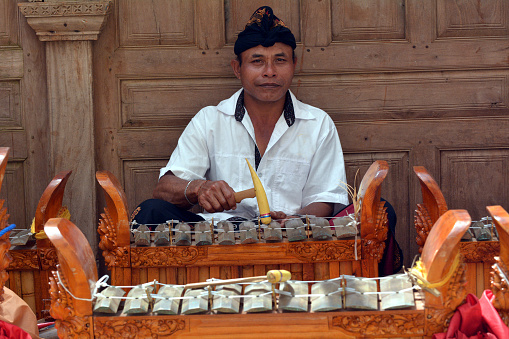 Balinese gamelan orchestra playing traditional music. Gamelan is the traditional ensemble music of Java and Bali in Indonesia, made up predominantly of percussive instruments.