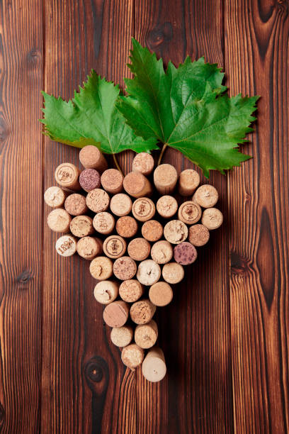 istock wine corks, grapevine, free copy space on wooden background - Image 