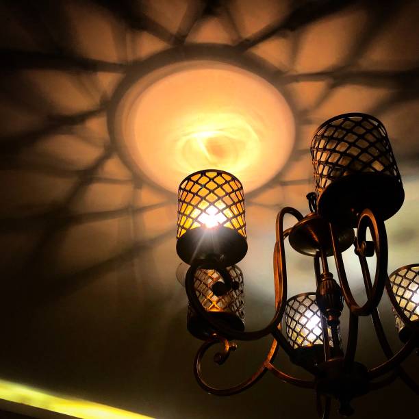 istock Chandelier lamp making beautiful patterns in the ceiling 1169090335