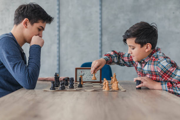 istock Two smart boys playing chess in school of chess 1169091628