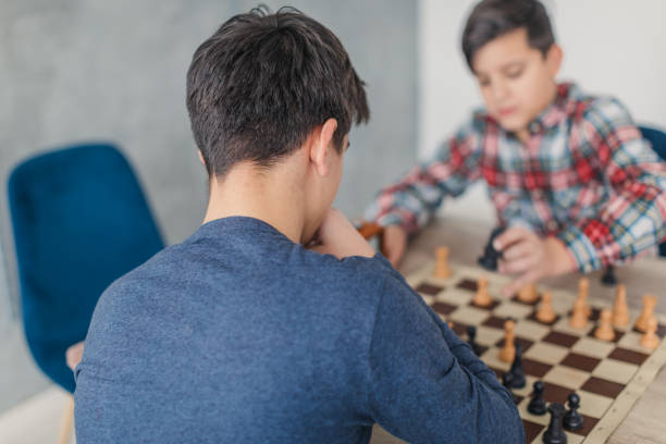 istock Boys playing a game of chess 1169092159