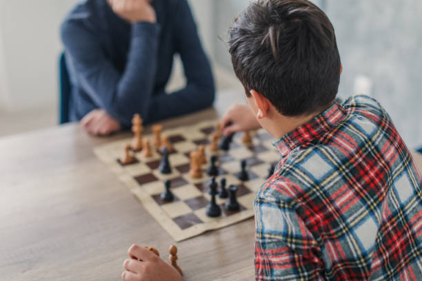 istock Boys playing a game of chess 1169093295