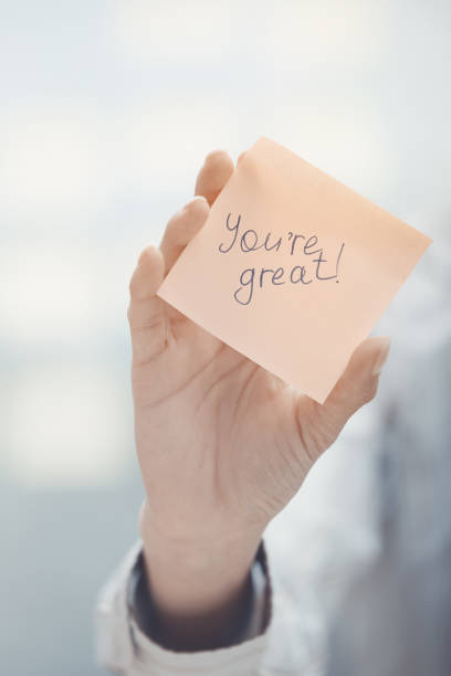 istock Woman holding sticky note with You are great text 1169093398