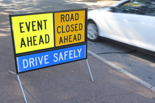 Road sign reading: Event Ahead road closes drive safely.