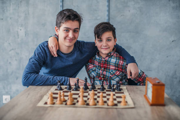 istock Two smart boys in chess school 1169093734