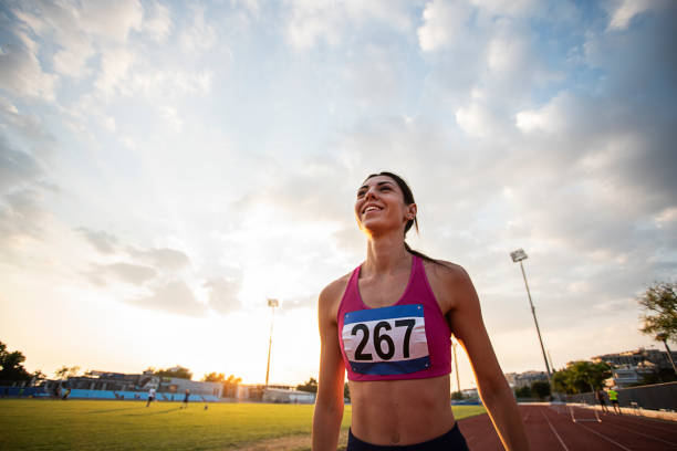 Athlete Woman Wins Athlete Woman Wins On Race Track track and field athlete stock pictures, royalty-free photos & images