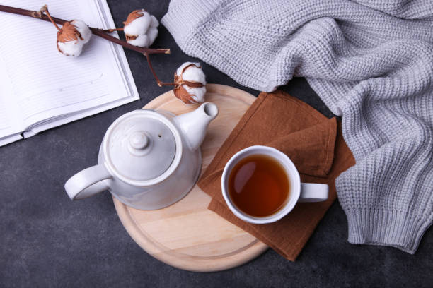 istock tea and teapot on cutting board, gray plaid 1169094084