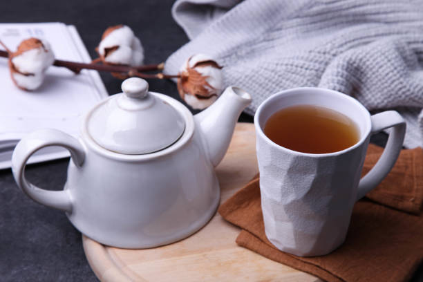 istock tea and teapot on cutting board, gray plaid 1169094085