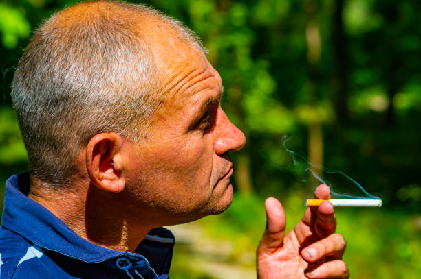 istock Man smoking cigarette at night, closeup. 1169094661