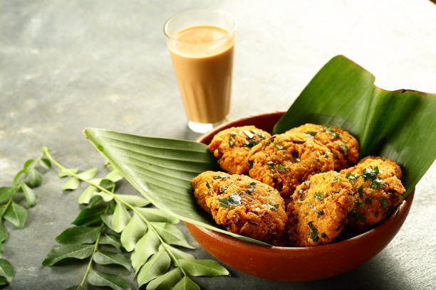 istock Indian cuisine- healthy snacks- parippu vada and milk tea. 1169097392