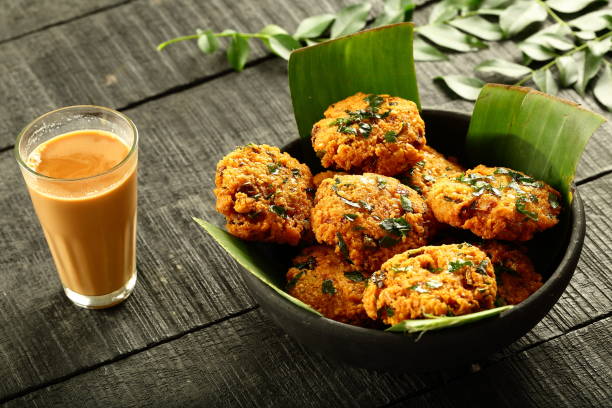 istock Spicy and hot parippu vada and Indian tea, 1169097759