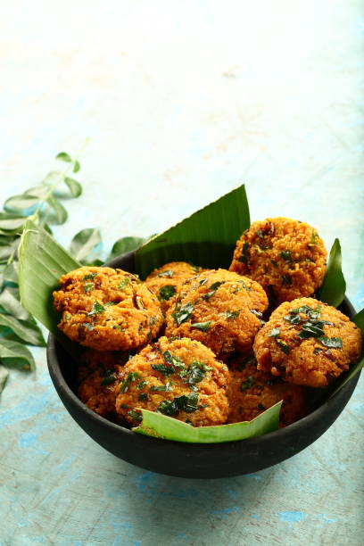 istock Bowl of vegan fried snack - parippu vada, 1169097969