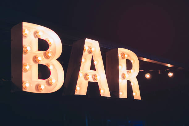 text bar on facade wall front building entrance cafe pub in street