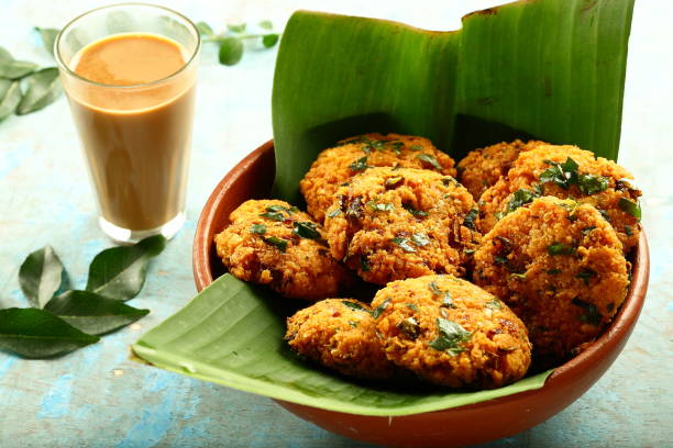 istock Indian cuisine- healthy snacks- parippu vada and milk tea. 1169098077