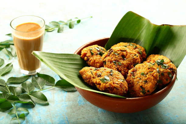 istock Indian cuisine- healthy snacks- parippu vada and milk tea. 1169098612