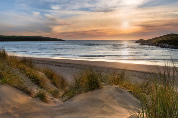 Sunlight over Dunes, Crantock Beach, on the beautiful north Cornwall coast. Sunlight over Dunes, Crantock Beach, on the beautiful north Cornwall coast. cornwall england stock pictures, royalty-free photos & images