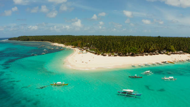 istock Tropical Daco Island with a sandy beach and tourists 1169100695