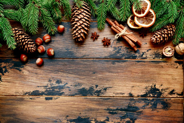 istock Fir tree branches and pine cones on a dark wooden background. 1169101678