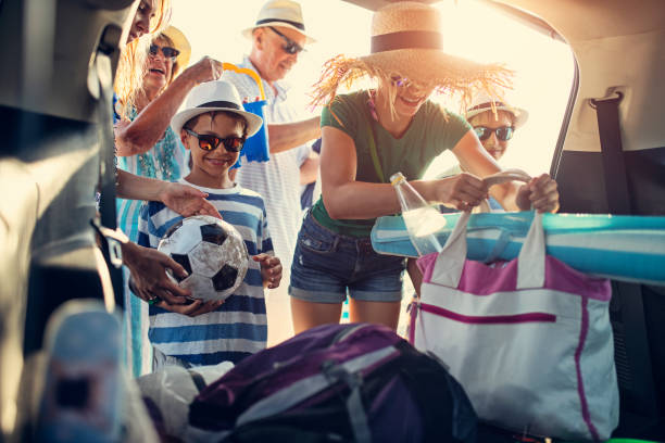 Multi generation family is packing car. Kids and grand parents returning to car from the beach. Family is packing the car.
Sunny summer day in Italy.
Nikon D850 beach bag stock pictures, royalty-free photos & images