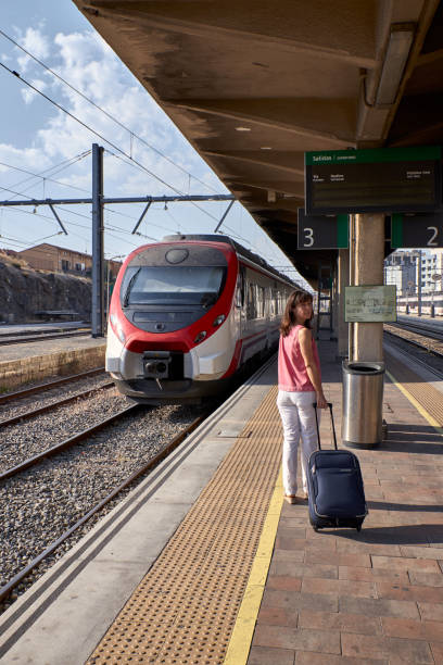 istock woman walking in a train station 1169102540